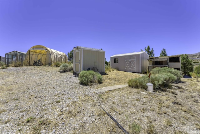 exterior space with an outbuilding and a shed