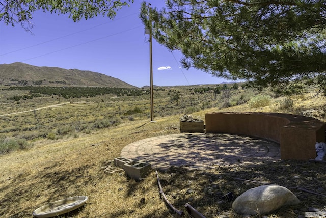 view of yard featuring a patio and a mountain view