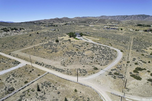 drone / aerial view with a mountain view, a rural view, and view of desert