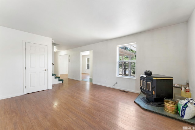 interior space featuring hardwood / wood-style floors and a wood stove