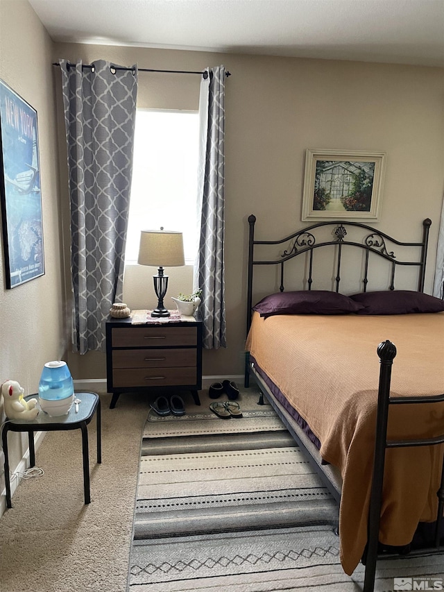 bedroom with carpet floors and baseboards