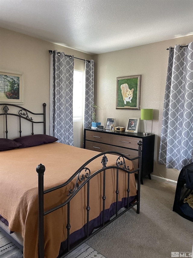 carpeted bedroom featuring a textured ceiling