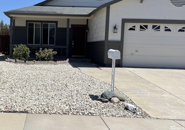 single story home featuring a garage, concrete driveway, and roof with shingles