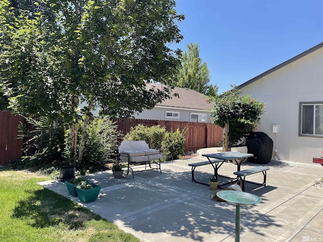 view of patio / terrace with a grill and fence