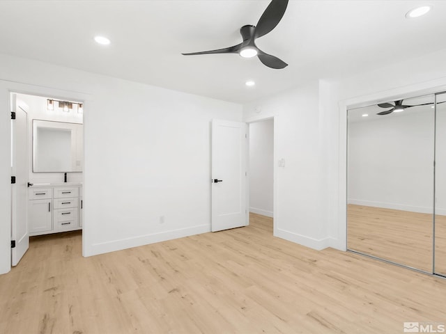 unfurnished bedroom with ceiling fan, light wood-type flooring, and a closet