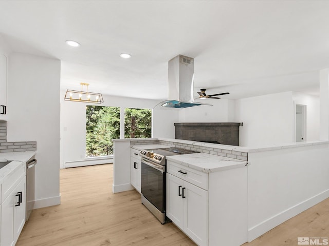 kitchen with appliances with stainless steel finishes, white cabinetry, island exhaust hood, kitchen peninsula, and light wood-type flooring