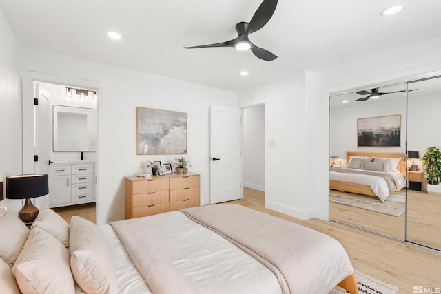 bedroom with light hardwood / wood-style flooring, ceiling fan, and a closet