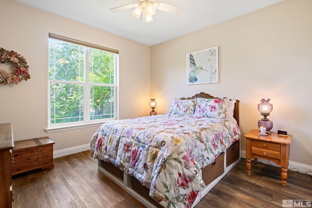 bedroom with dark wood-style flooring, a ceiling fan, and baseboards