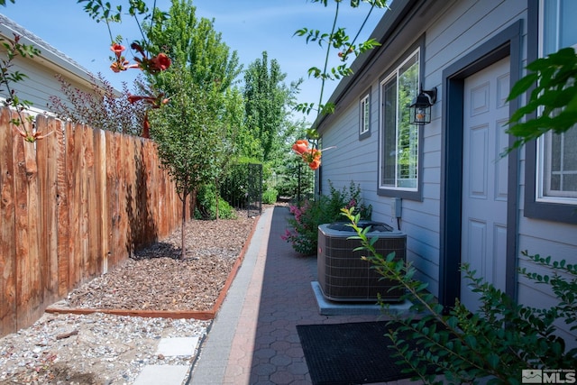 view of yard featuring fence and central AC unit