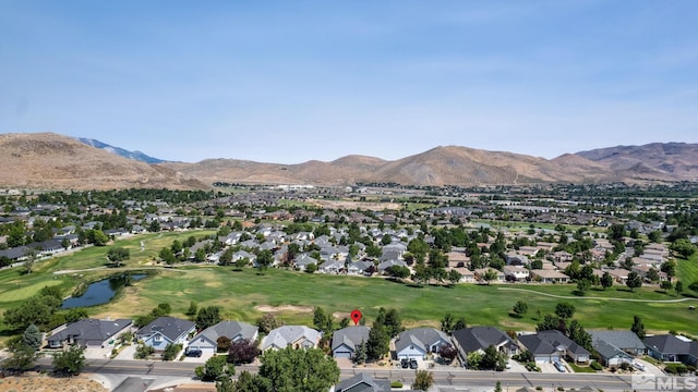 drone / aerial view with view of golf course, a residential view, and a mountain view