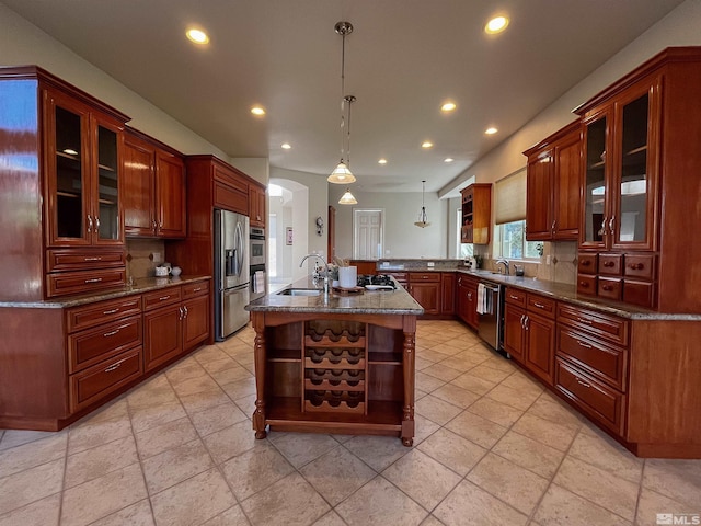 kitchen with light tile patterned flooring, tasteful backsplash, kitchen peninsula, stainless steel appliances, and sink