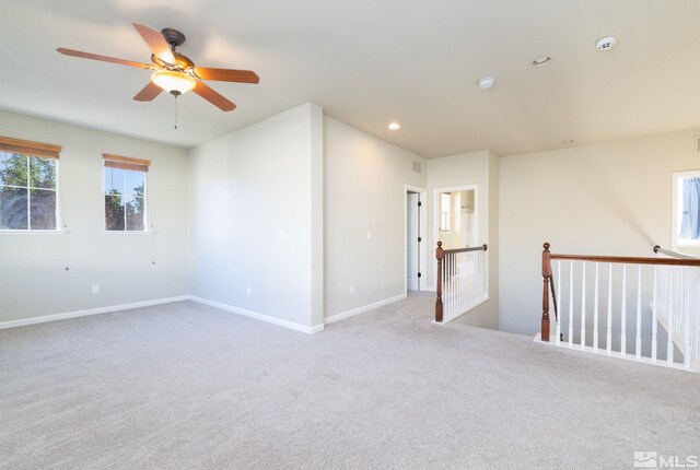 carpeted bedroom featuring multiple windows and ceiling fan