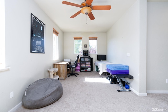 carpeted office featuring ceiling fan