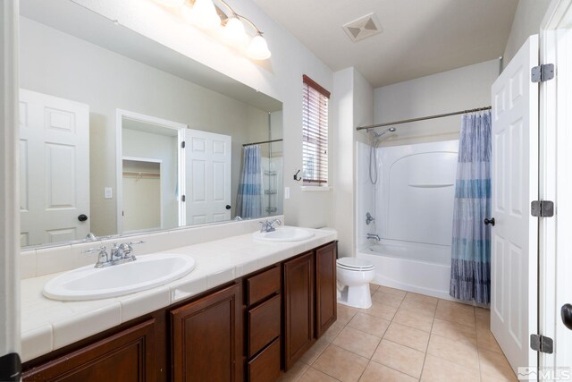 washroom featuring separate washer and dryer, cabinets, and light tile patterned floors