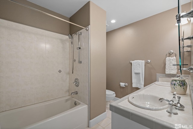 full bathroom with dual vanity, tile patterned floors, tiled shower / bath, and toilet