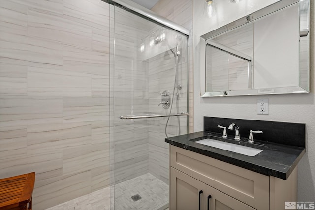 bathroom featuring vanity and an enclosed shower