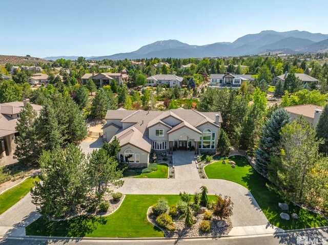 mediterranean / spanish home featuring a front lawn and a mountain view