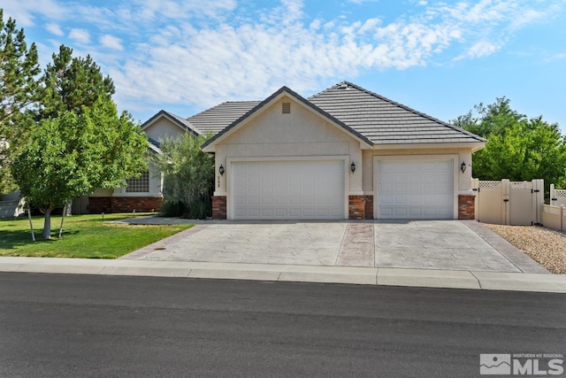 ranch-style house with a garage and a front lawn