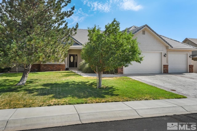 view of property hidden behind natural elements featuring a garage and a front yard