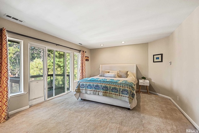 bedroom with light carpet and access to exterior