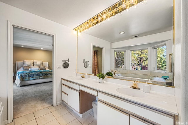 bathroom featuring vanity, a tub, and tile patterned floors