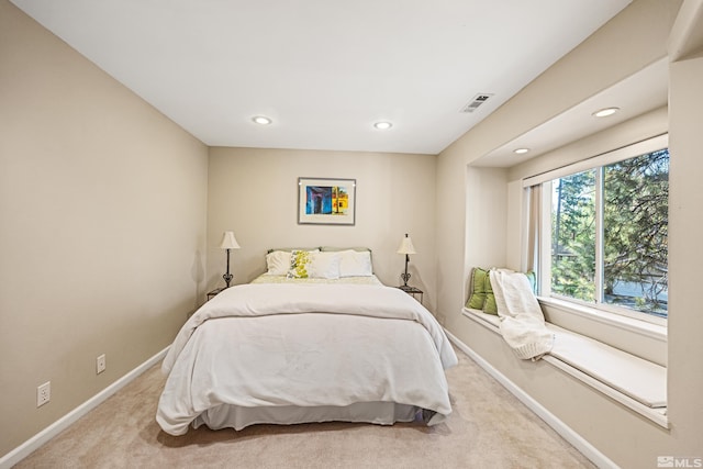 bedroom with light colored carpet