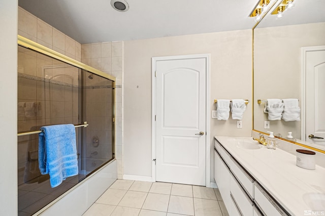 bathroom with tile patterned floors, vanity, and shower / bath combination with glass door