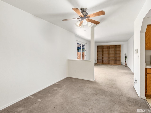 unfurnished room featuring a ceiling fan, baseboards, and carpet floors