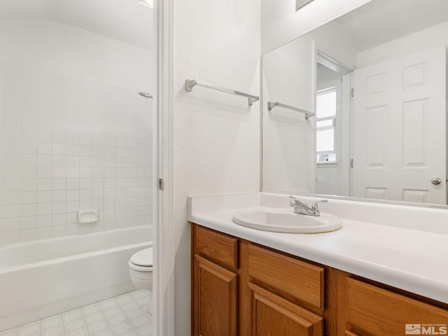 bathroom featuring vanity, tile patterned floors, toilet, and tub / shower combination