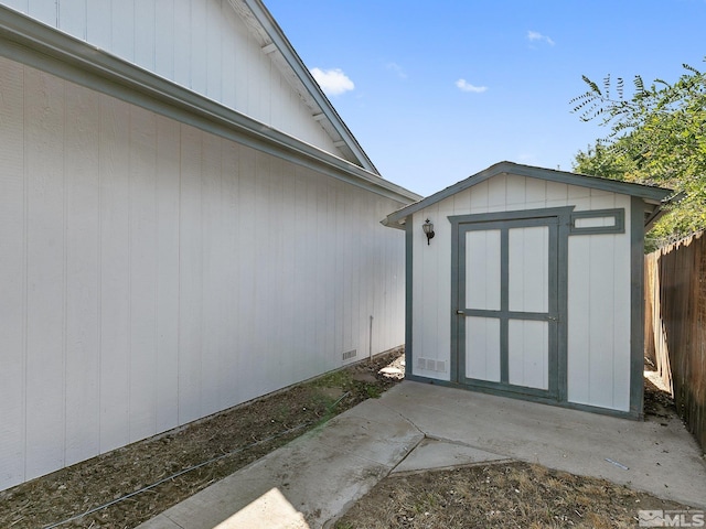 view of shed featuring fence