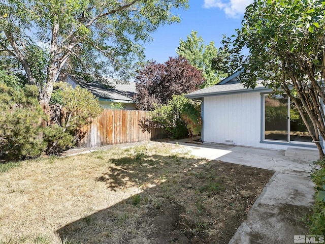 view of yard featuring a patio and fence