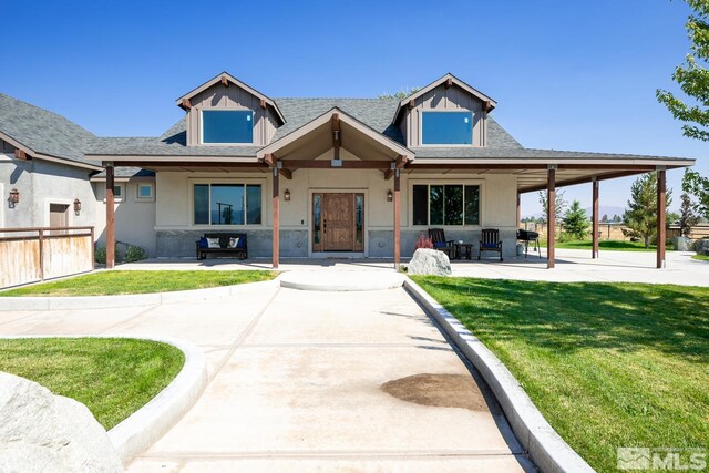 view of front of house featuring a patio area and a front lawn