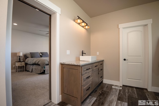 bathroom with vanity, ceiling fan, and hardwood / wood-style flooring