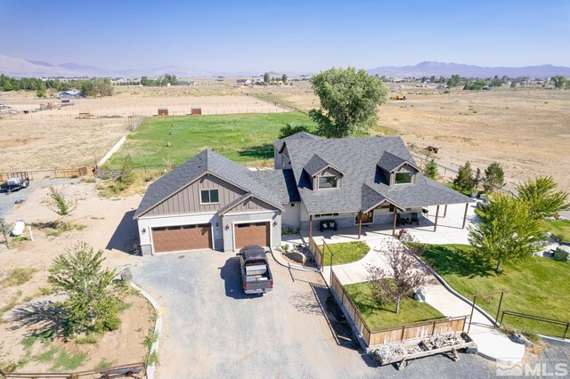 birds eye view of property with a mountain view and a rural view