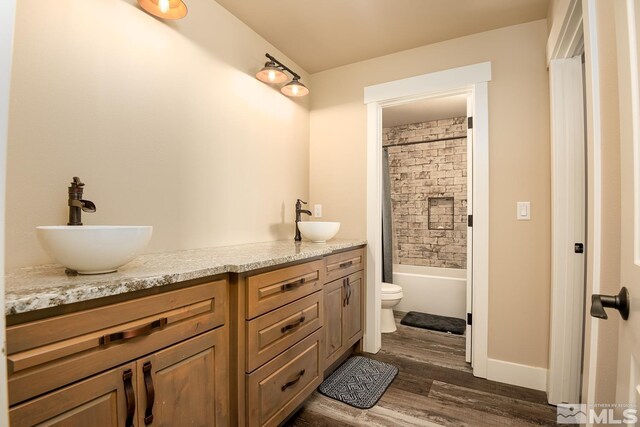 full bathroom featuring bathing tub / shower combination, vanity, toilet, and hardwood / wood-style floors