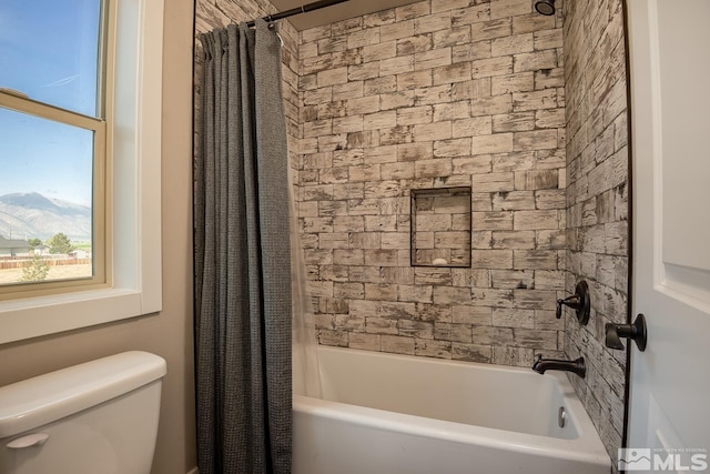 bathroom featuring shower / tub combo with curtain and toilet