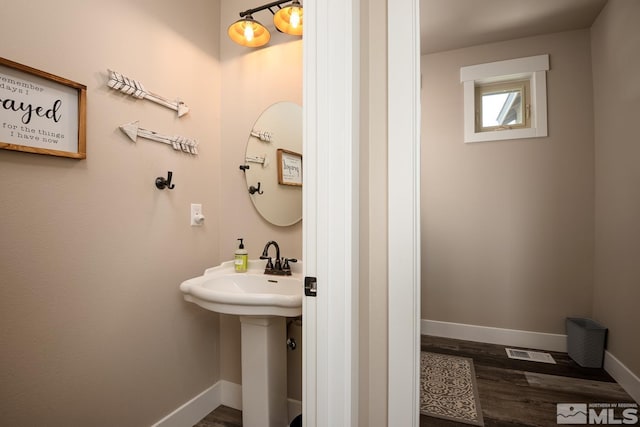 bathroom with sink and hardwood / wood-style floors