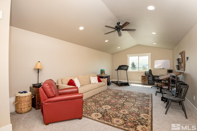 carpeted living room with ceiling fan and vaulted ceiling