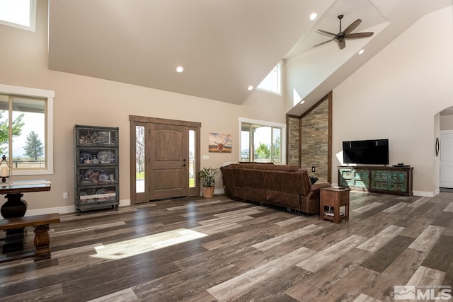 foyer entrance featuring ceiling fan, high vaulted ceiling, and dark wood-type flooring