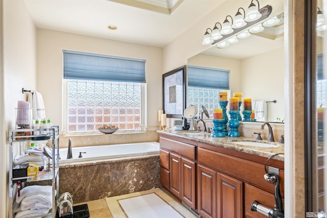 bathroom with vanity and tiled tub