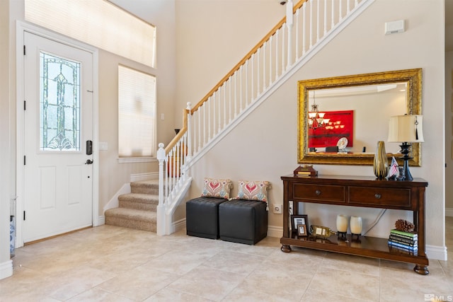 tiled entryway with a towering ceiling