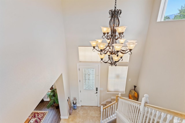 entrance foyer with a towering ceiling and a chandelier