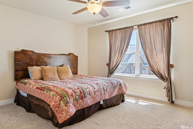 carpeted bedroom with multiple windows and ceiling fan