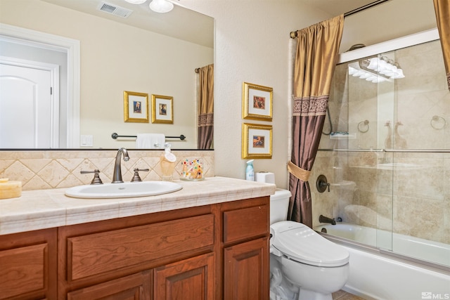 full bathroom featuring tasteful backsplash, bath / shower combo with glass door, vanity, and toilet