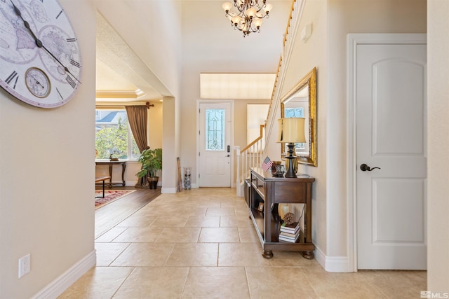 tiled foyer with a chandelier