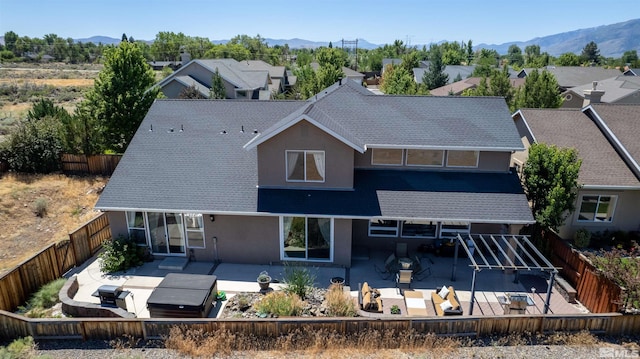 back of house featuring a mountain view and a patio area