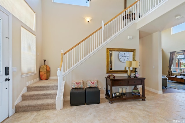 foyer entrance with a high ceiling and light tile patterned floors