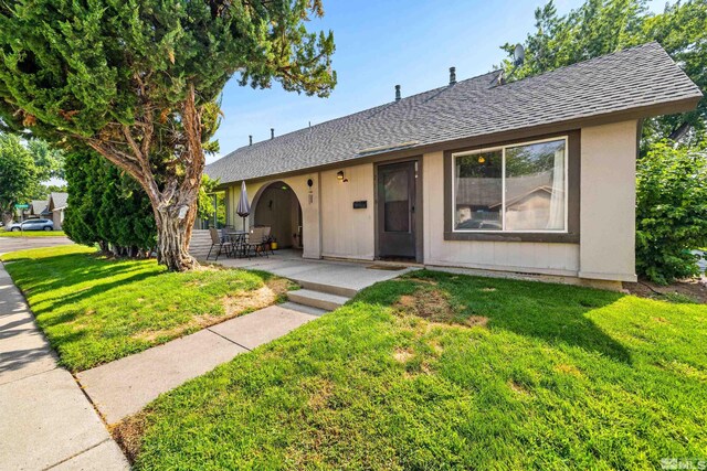 single story home featuring a front yard and a patio area