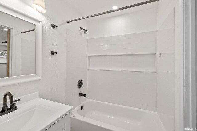 bathroom with walk in shower, vanity, and toilet