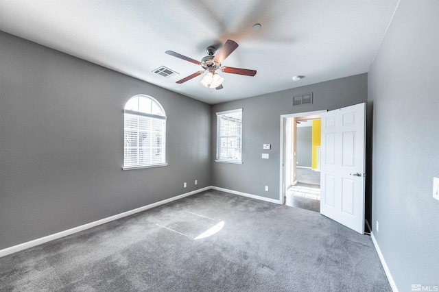 unfurnished living room with ceiling fan with notable chandelier and carpet floors